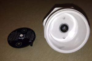 A 1.5" diameter PVC end cap machined to mount the MS5803 disc. Two 6-32 holes are tapped, spaced 0.5" from the center hole that accomodates a barbed fitting machined to hold the o-ring that seals against the MS5803. 
