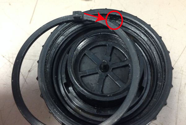 Not the tang on the retaining ring that needs to fit down in the slot in the valve body cap. The retaining ring needs to be turned over from its position in this picture before installation.