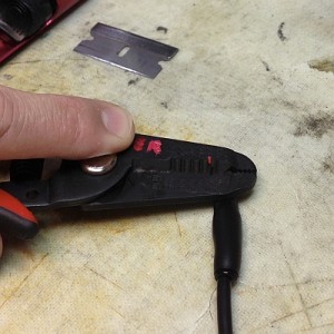 Like the first layer of heat shrink, I use pliers to smash the end of the cap flat while it is still hot and flexible. 